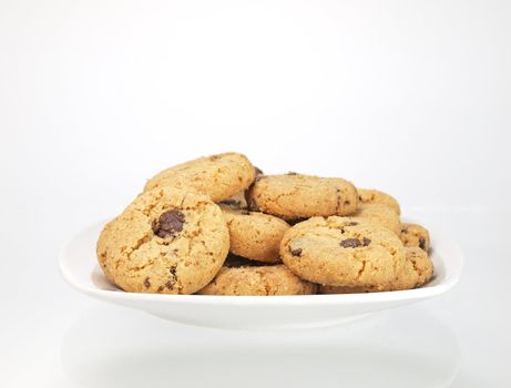 bowl of chocolate chip cookies on white background