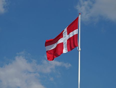 flapping danish flag on clear blue sky