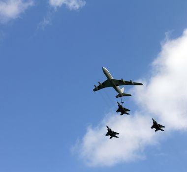 Israeli Air Force airplanes (four-engine turboprop powered refueling tanker  and three jet fighters) imitating aerial refueling at parade in honor of Independence Day