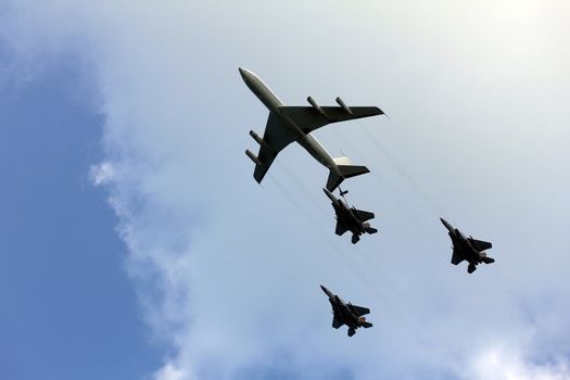 Israeli Air Force airplanes (four-engine turboprop powered refueling tanker  and three jet fighters) imitating aerial refueling at parade in honor of Independence Day