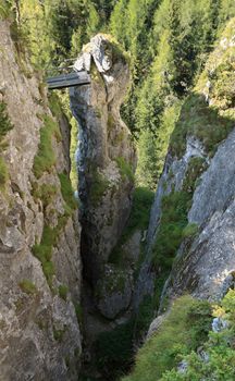 via ferrata Sass de rocia with a metal bridge on top of a monolith, Italian Dolomites