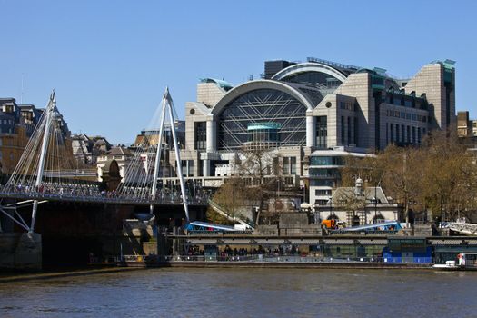 Charing Cross Station, the Hungerford Bridge and the River Thames in London.