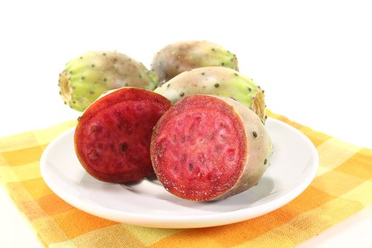succulent cactus figs on a plate in front of light background