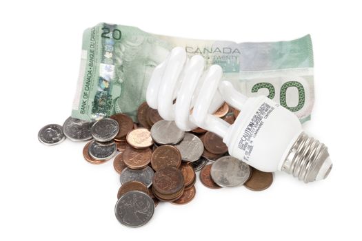 Close up image of light bulb, dollar and coins against white background