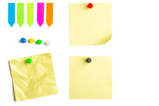 A mix of office supplies with sticky notes and pushpins