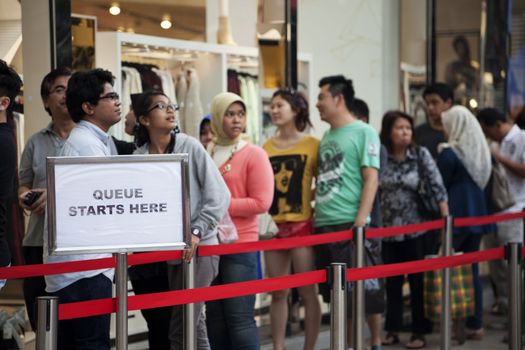 30 September 2012: Kuala Lumpur, Malaysia. Customers on the waiting line to enter the new H&M store opened 22 of September 2012  in Bukit Bintang