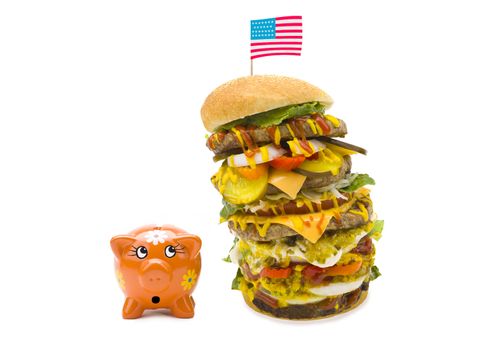 An enormous burger with many layers topped with the American flag.
