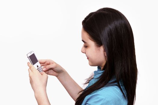 Teenage girl using smart phone on white background