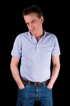 Grumpy Frowning Middle Age Man with Hands in Pockets Black Background