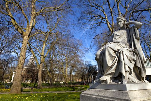 Sarah Siddons statue on Paddington Green with St.Mary's Church in the background, London.