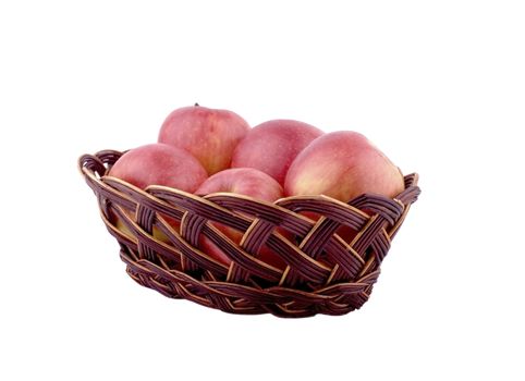 Red apples in a brown wicker basket on a white background