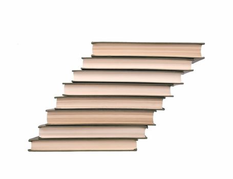 Several books stacked in stages, isolated on white background