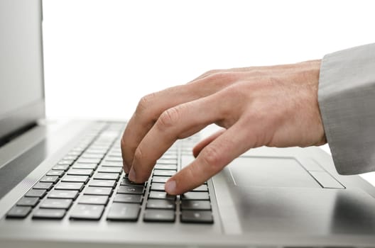 Detail of business man hand using laptop. Isolated over white background.