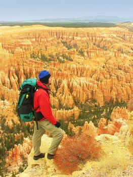 Backpacker resting at Inspiration Point, Bryce Canyon National Park, Utah, USA