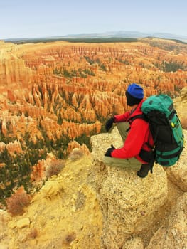 Backpacker resting at Inspiration Point, Bryce Canyon National Park, Utah, USA