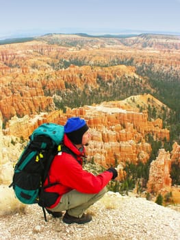 Backpacker resting at Inspiration Point, Bryce Canyon National Park, Utah, USA