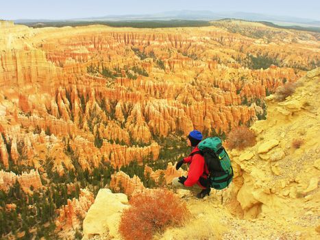 Backpacker resting at Inspiration Point, Bryce Canyon National Park, Utah, USA