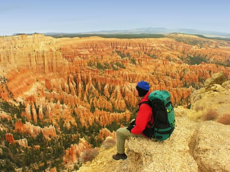 Backpacker resting at Inspiration Point, Bryce Canyon National Park, Utah, USA