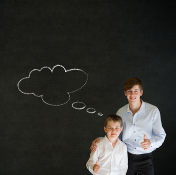 Thumbs up boy dressed up as business man with teacher man and thought thinking chalk cloud on blackboard background