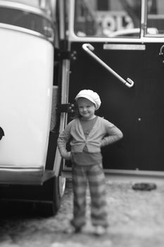 self confident, little girl at a 1950´s travel bus door