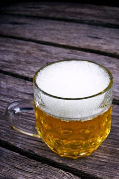 Glass beer on wood background