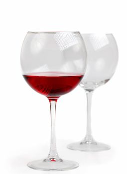 Empty and full glass goblet with red wine isolated on white