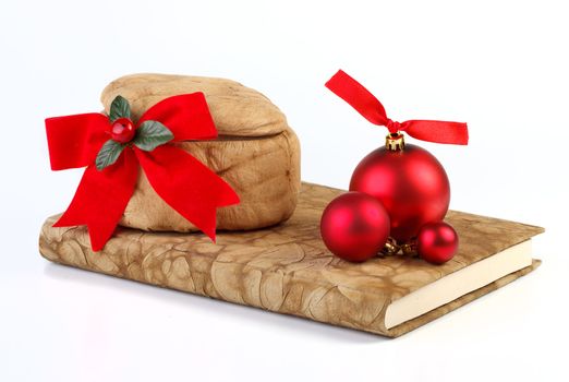 The book, box, and three red balls on white background