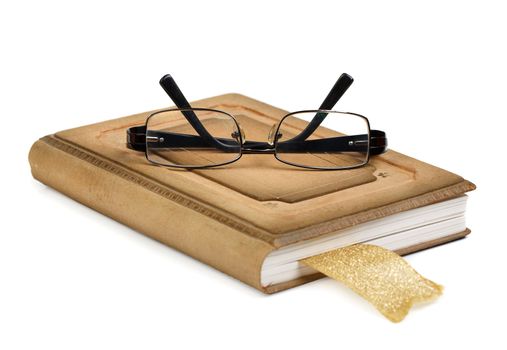 Glasses on a book isolated on white