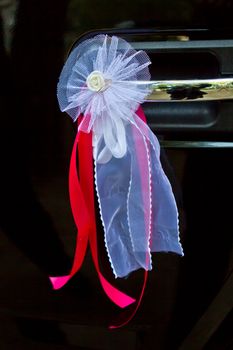 Door of wedding car with flower and ribbon