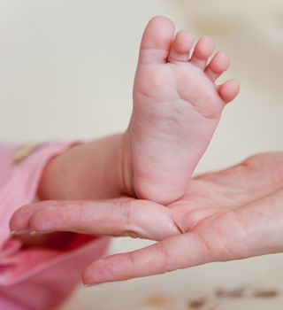 Mothers hand and the Baby`s Fee