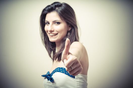 vintage portrait of young woman doing ok on vignetting background