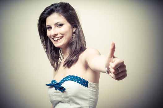 vintage portrait of young woman doing ok on vignetting background