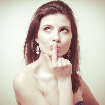 vintage portrait of young woman thinking on vignetting background