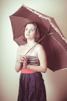 vintage portrait of young woman with umbrella on white background