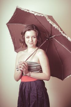 vintage portrait of young woman with umbrella on white background