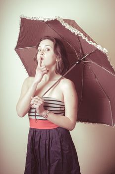 vintage portrait of young woman with umbrella on white background