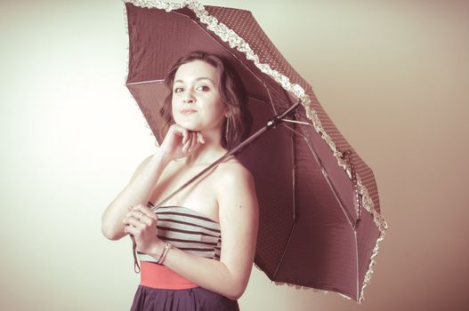 vintage portrait of young woman with umbrella on white background
