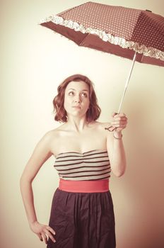 vintage portrait of young woman with umbrella on white background