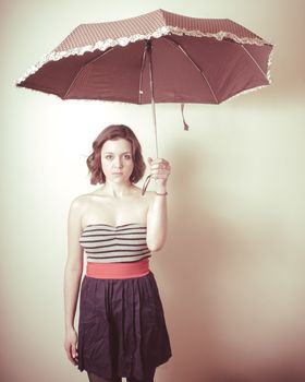 vintage portrait of young woman with umbrella on white background