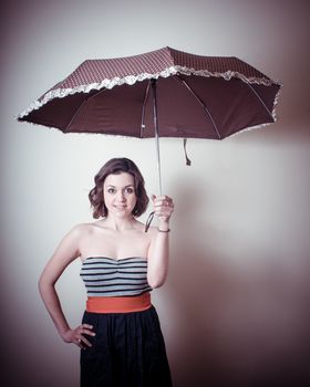 vintage portrait of young woman with umbrella on white background