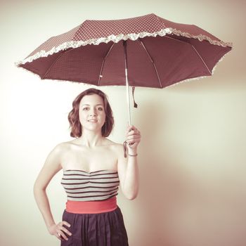 vintage portrait of young woman with umbrella on white background