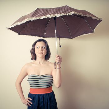 vintage portrait of young woman with umbrella on white background