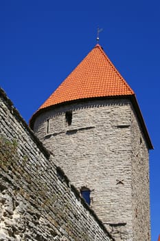 Wall and tower on a background of the blue sky