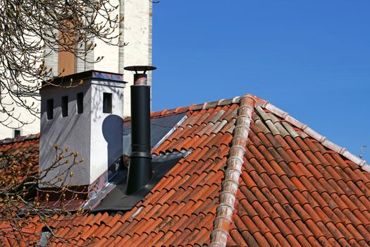 Chimney on a background of the sky and roof