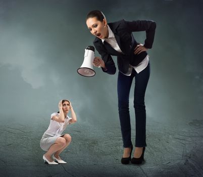 Business woman yelling at a small woman sitting on the ground, the concept of aggression