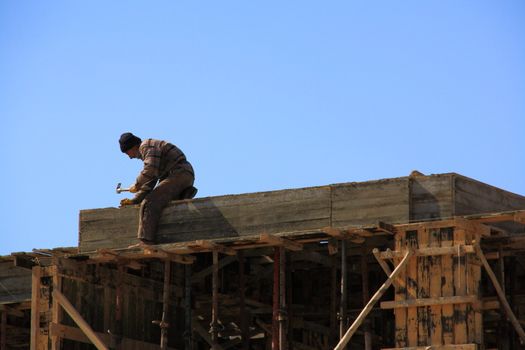 worker fixing woods for constructing building and making it ready for cement