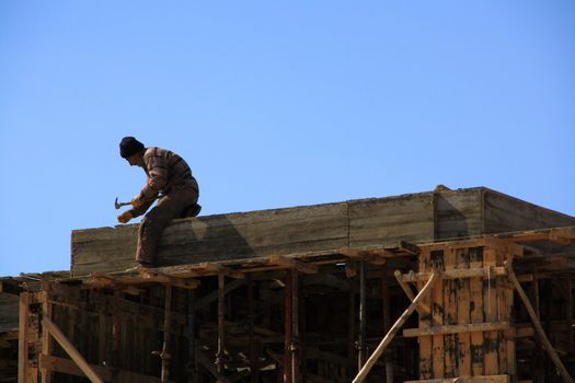 worker fixing woods for constructing building and making it ready for cement