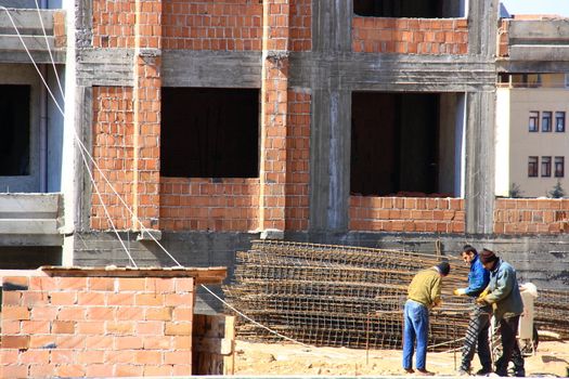 workers having fixing steels for construction of building