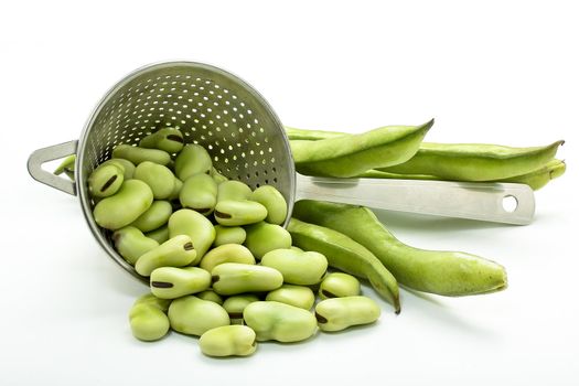 some raw broad beans on white background