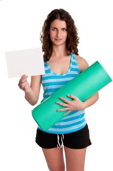 Woman holding a yoga mat and a white empty card, isolated in a white background